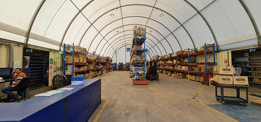 The interior of a dome shelter with well-arranged shelves and storage solutions for industrial use.