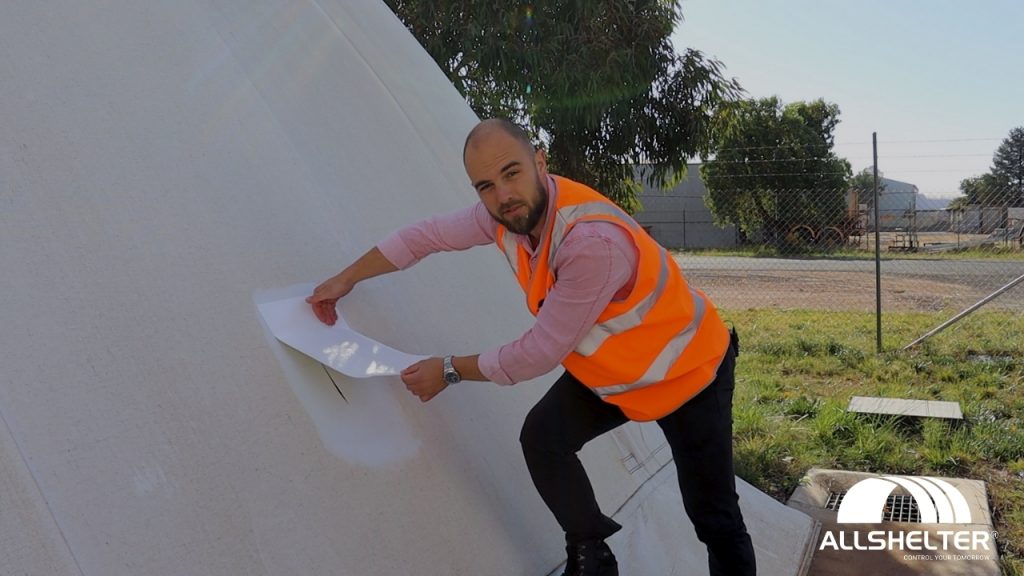 image showing the repair tape being placed onto the shelter