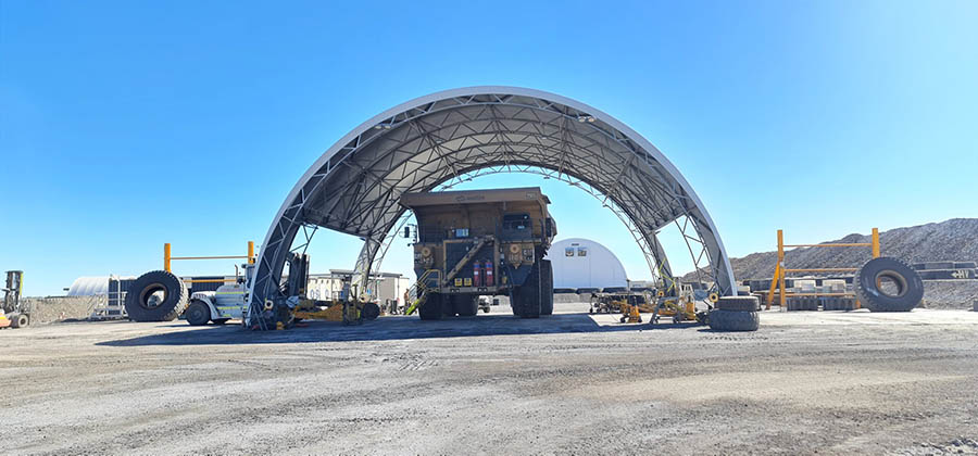 A durable dome shelter designed to protect heavy vehicles in industrial workshops and mining sites.