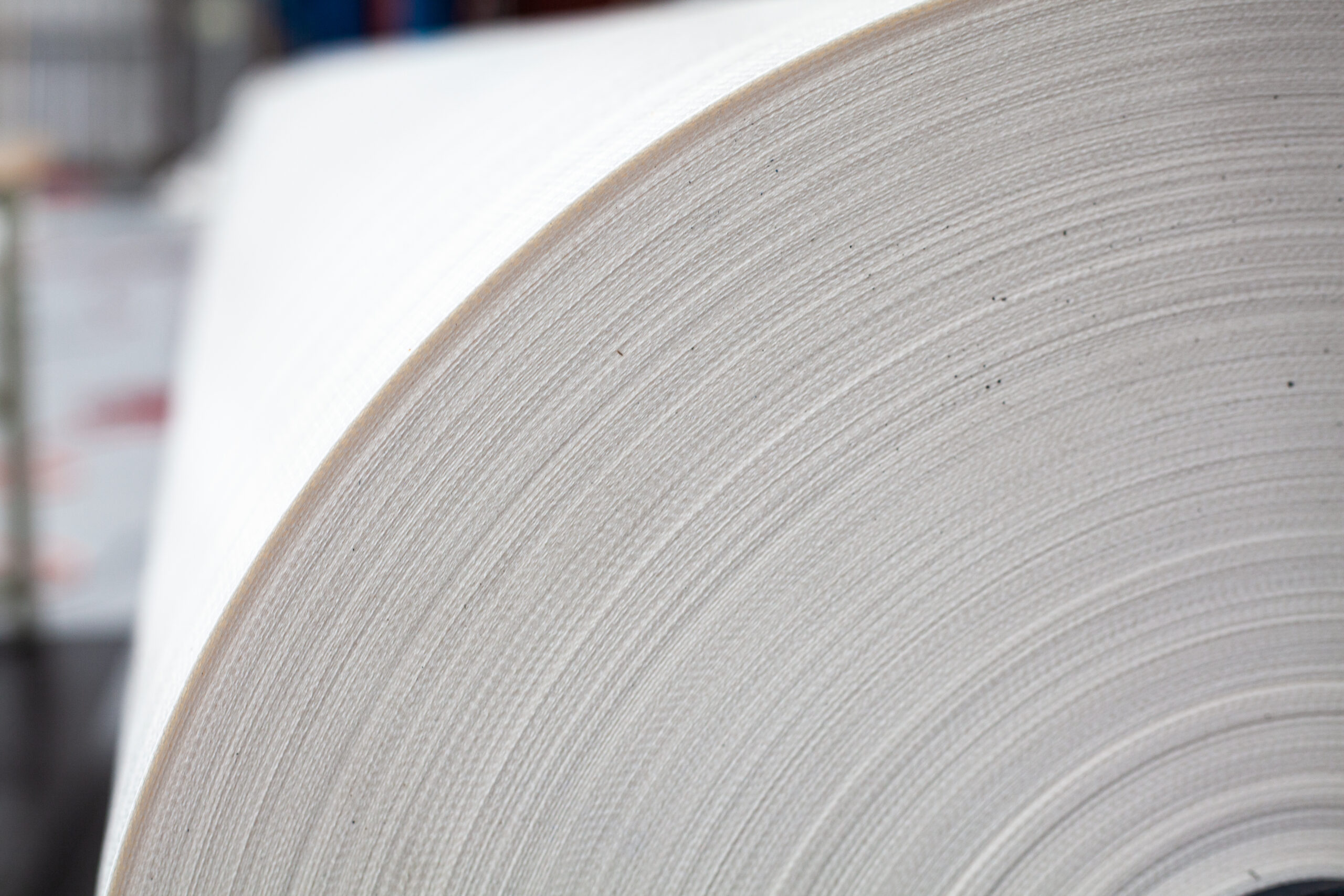 A close-up view of a high-quality fabric roll used in shelter construction for maximum durability and weather resistance.