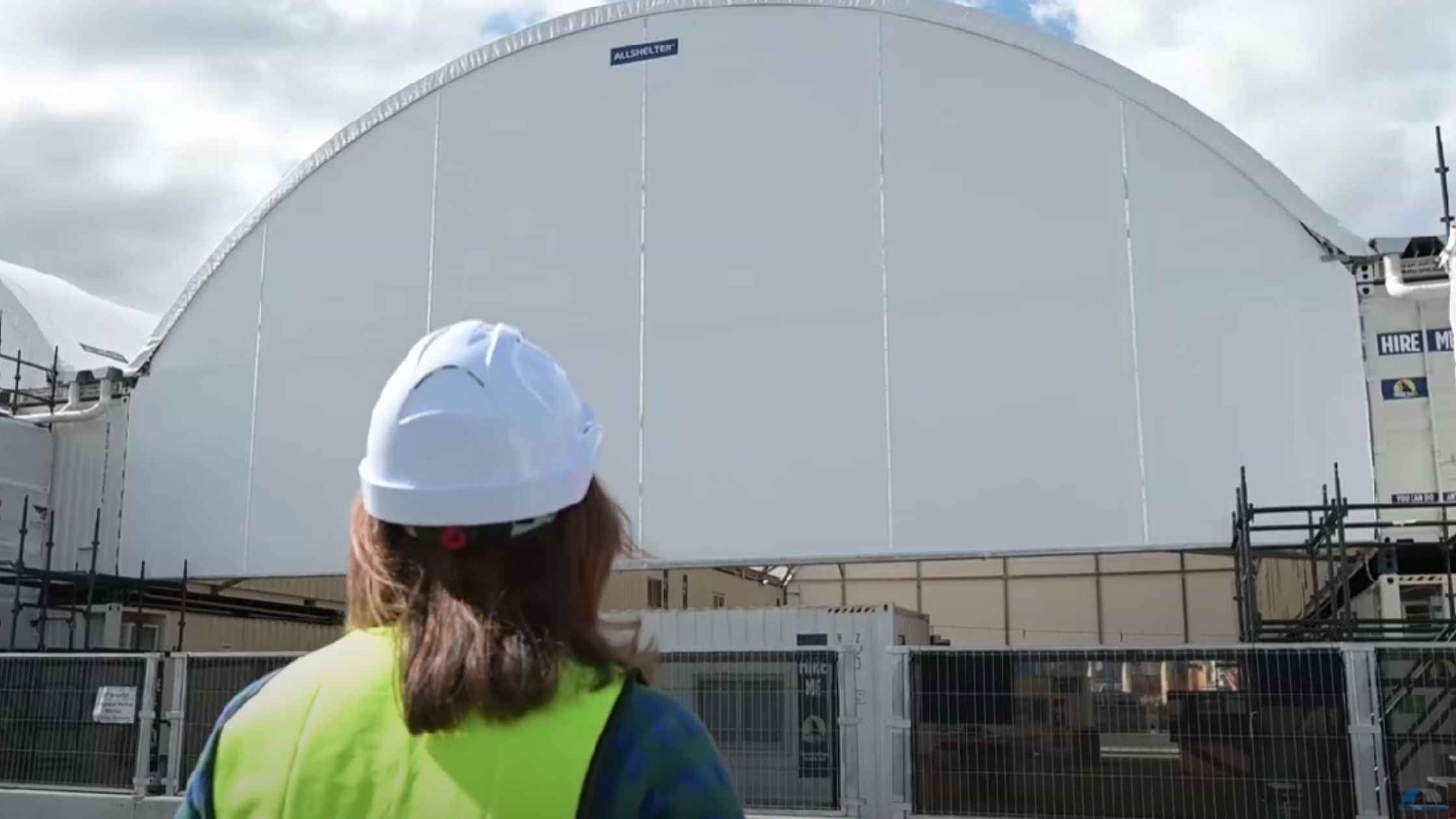 Worker inspecting large fabric shelter with Customisation Options